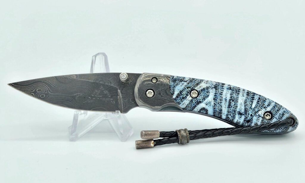 castlegate-manual-folder-2-375-416-layer-damascus-drop-point-blade-blue-brain-coral-handle-scales-with-titanium-liners-damascus-bolster-with-diamond-inlayed-thumb-stud-custom-leather-sheat